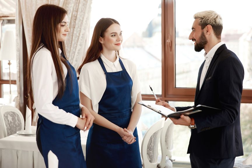 Three hospitality workers talking