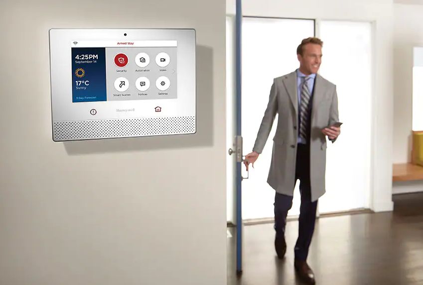 an MB secure device on a wall with a figure in the background