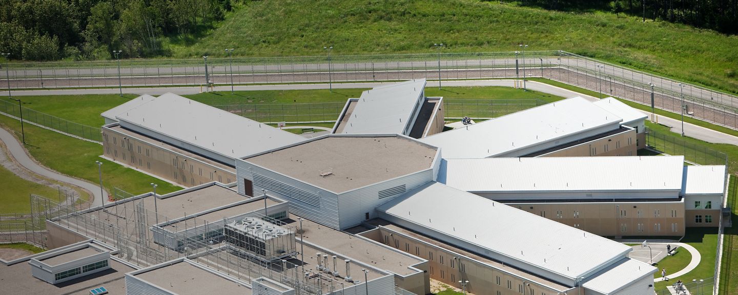 A modern podular prison cell block aerial view. The pod with wings decentralizes prisoners into smaller groups for easier control. Outdoor areas are separated to prevent large gatherings of prisoners. http://www.banksphotos.com/LightboxBanners/Aerial.jpg