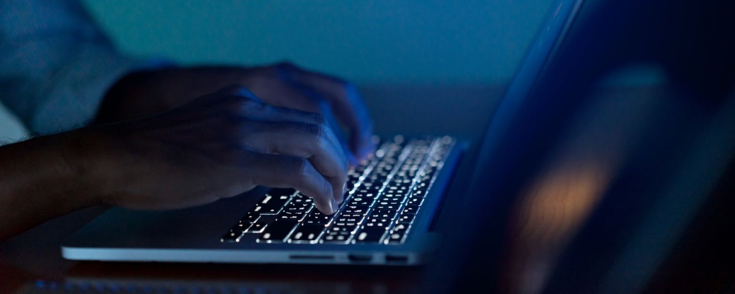 Close up businessman hand typing or working on laptop for programming about cyber security , advance future technology concept