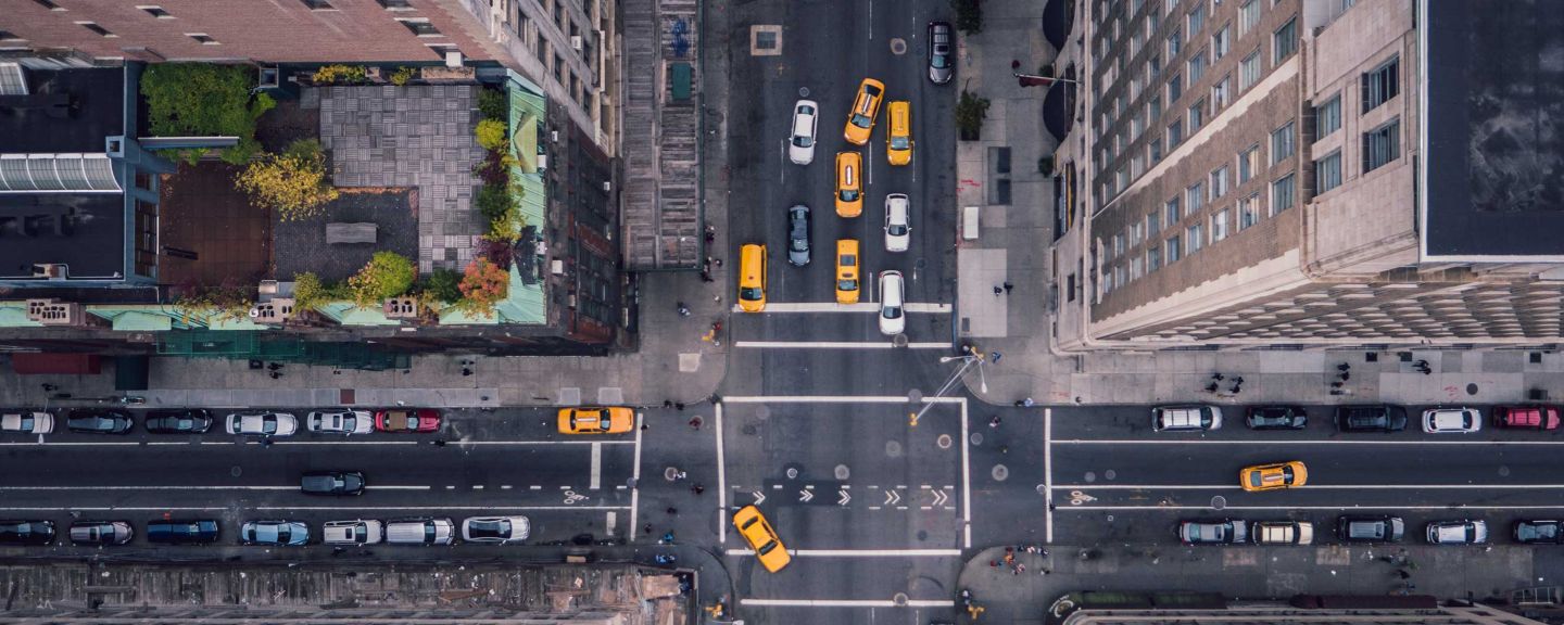 An aerial view of NYC streets with yellow cabs.