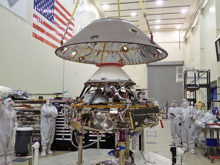 The back shell of the InSight spacecraft is lowered onto the lander in a clean room at Lockheed Martin.