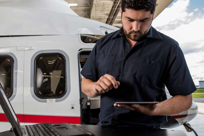 Technician using iPad on Helicopter
