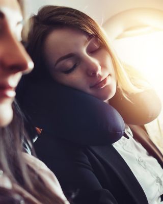 Lady sleeping in an airplane