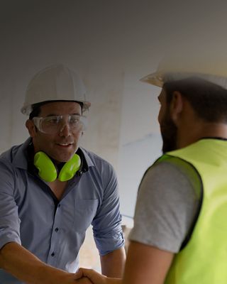 Guys in hardhats shaking hands