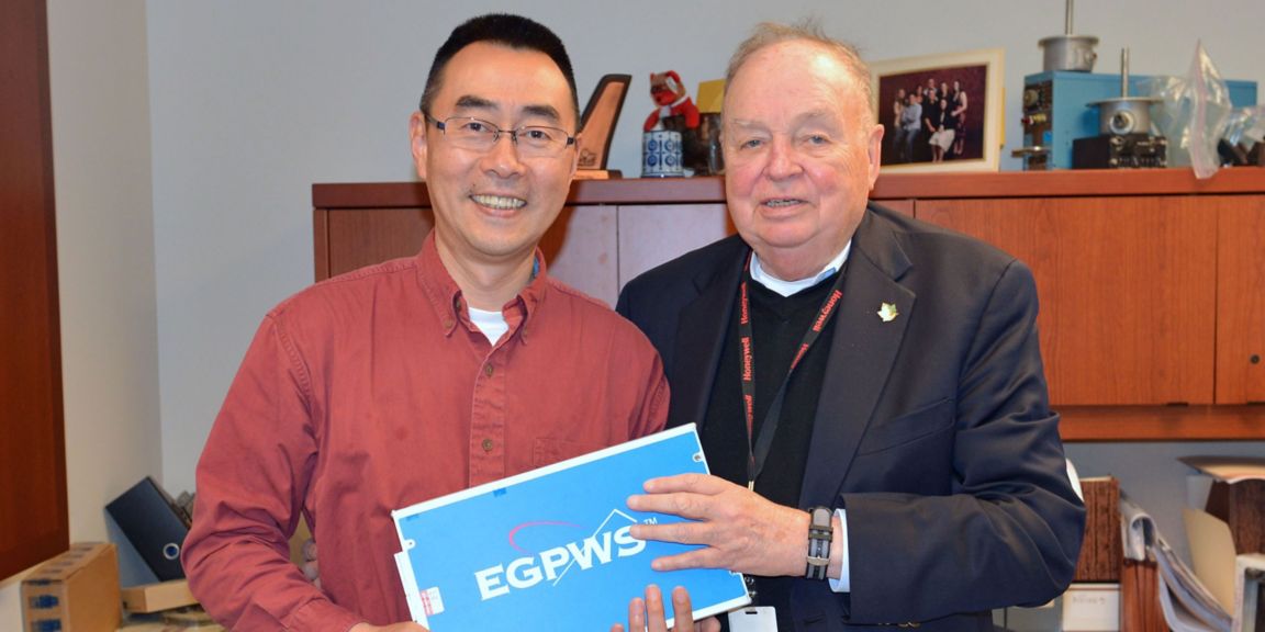 Yasuo Ishihara and Don Bateman holding an EGPWS box.