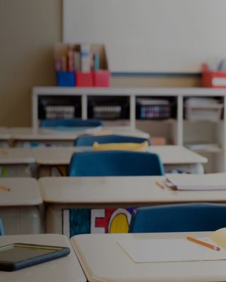 Classroom without children at school's out. The desks are in rows and you can read the names of the children on the front of the desks drawn in multicolour. Photo was taken in elementary school in Quebec Canada.