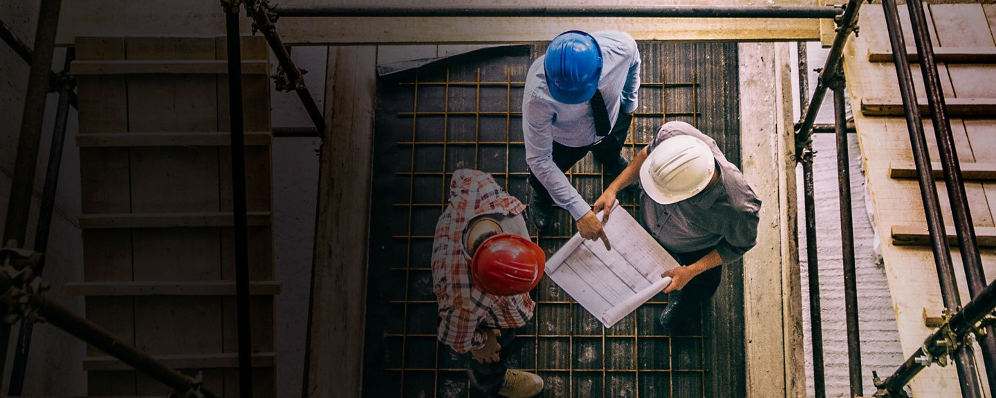 Construction crew reviewing blueprints