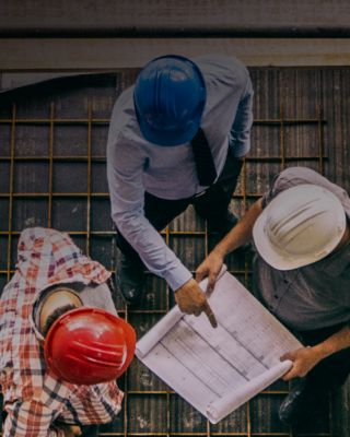 Construction crew reviewing blueprints