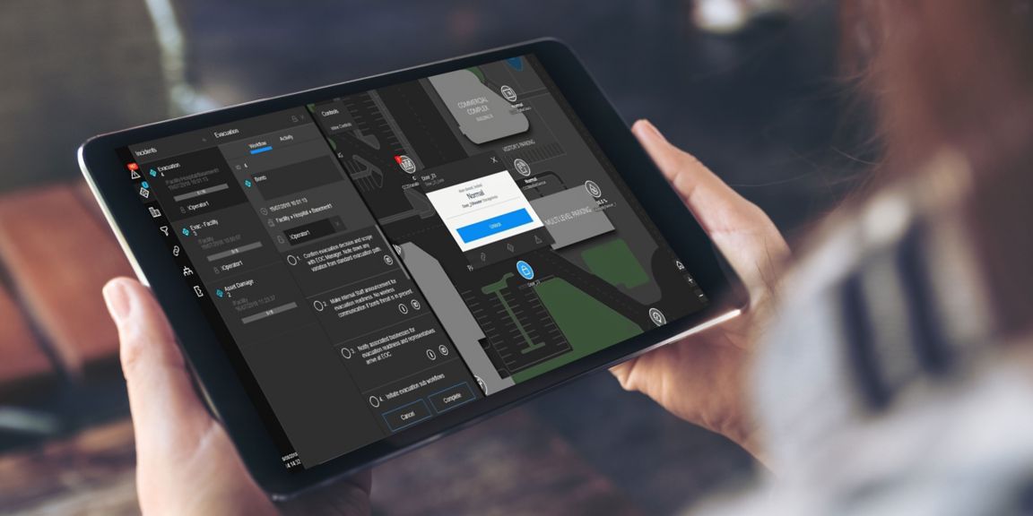 Mockup image of a woman holding and using black tablet pc with white blank screen 