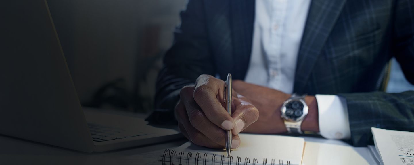 Man writing notes on pad