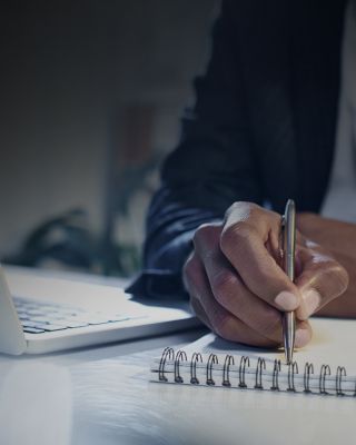 Man writing notes on pad