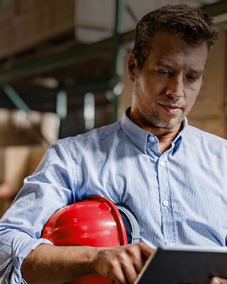 Warehouse manager reviewing tablet