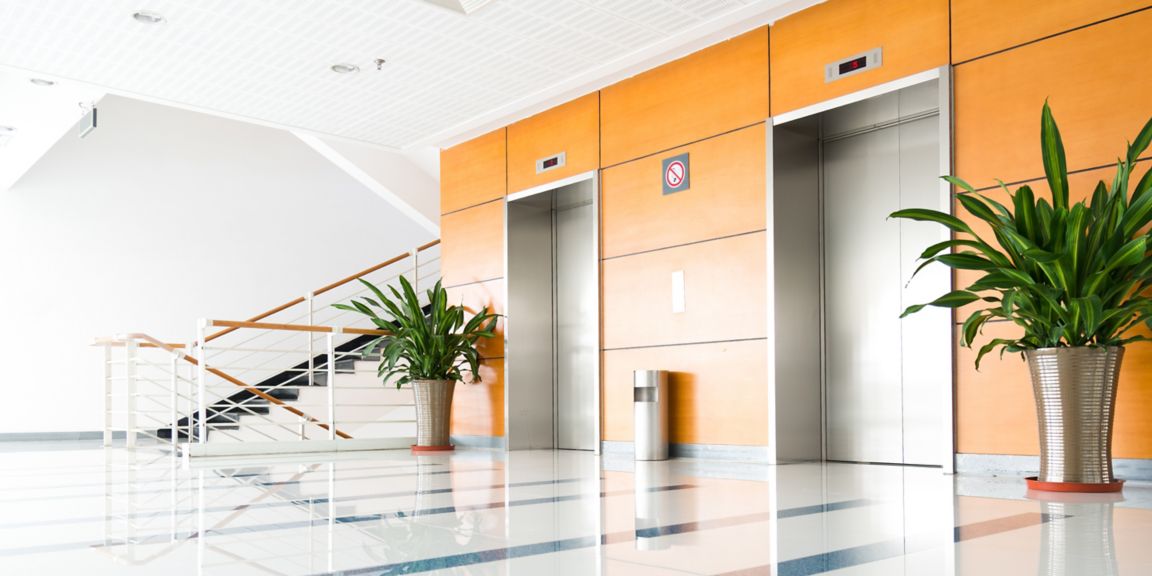 Two elevators in a lobby