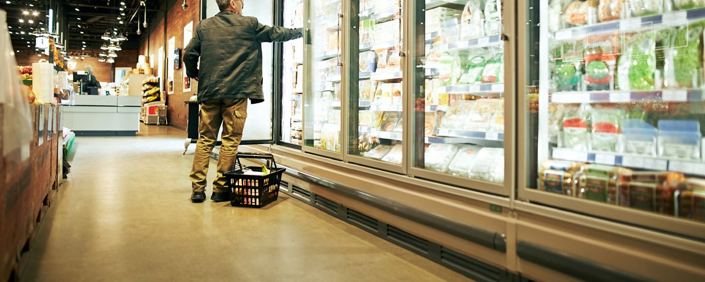 Shot of a mature man shopping in the cold produce section of a supermarket