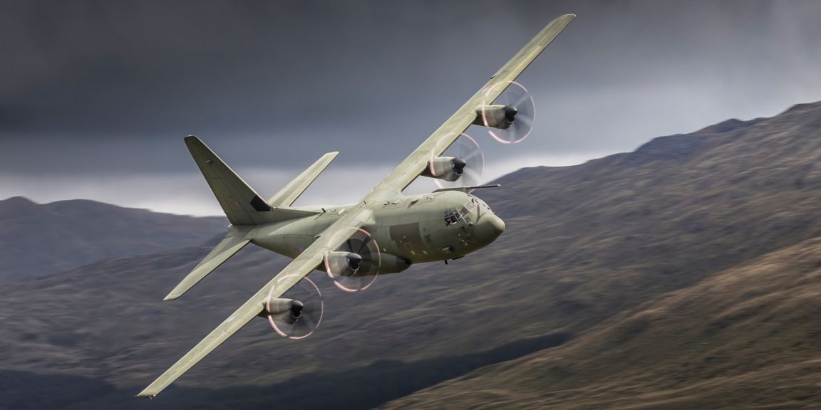 Royal Air Force C-130 Hercules transport aeroplane flying low level in the UK low fly system