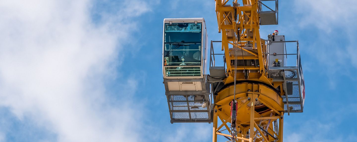 Close up details with a cabin control of a construction crane.Turret Slewing Crane against blue sky