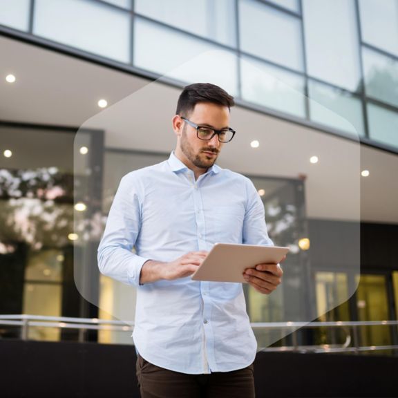 Happy and confident businessman using tablet