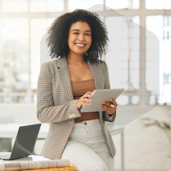 Happy and confident businessman using tablet