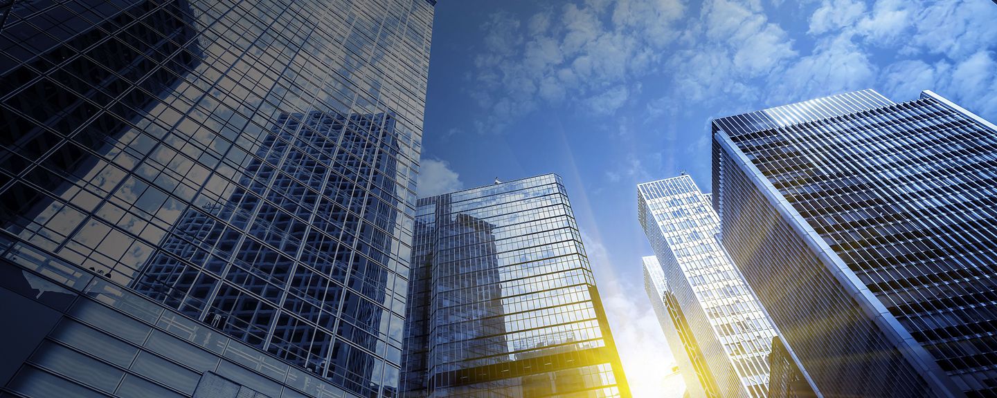 Tall buildings with sunlight reflecting off the windows