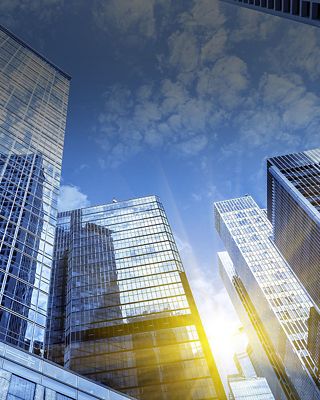 Tall buildings with sunlight reflecting off the windows