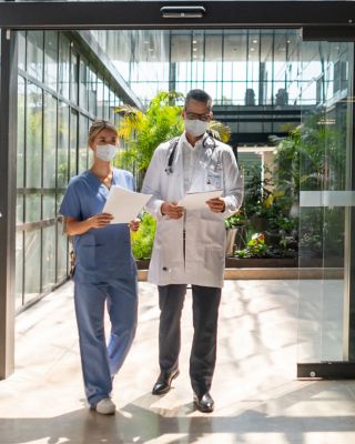 People walking in and out of the hospital - Healthcare concepts