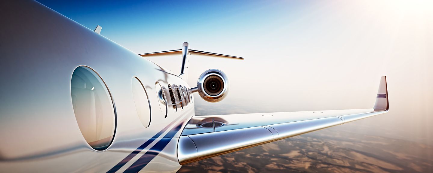 Photo of White Luxury Generic Design Private Jet Flying in Blue Sky at sunset.Uninhabited Desert Mountains Background.Business Travel Picture.Horizontal,Film Effect. 3D rendering