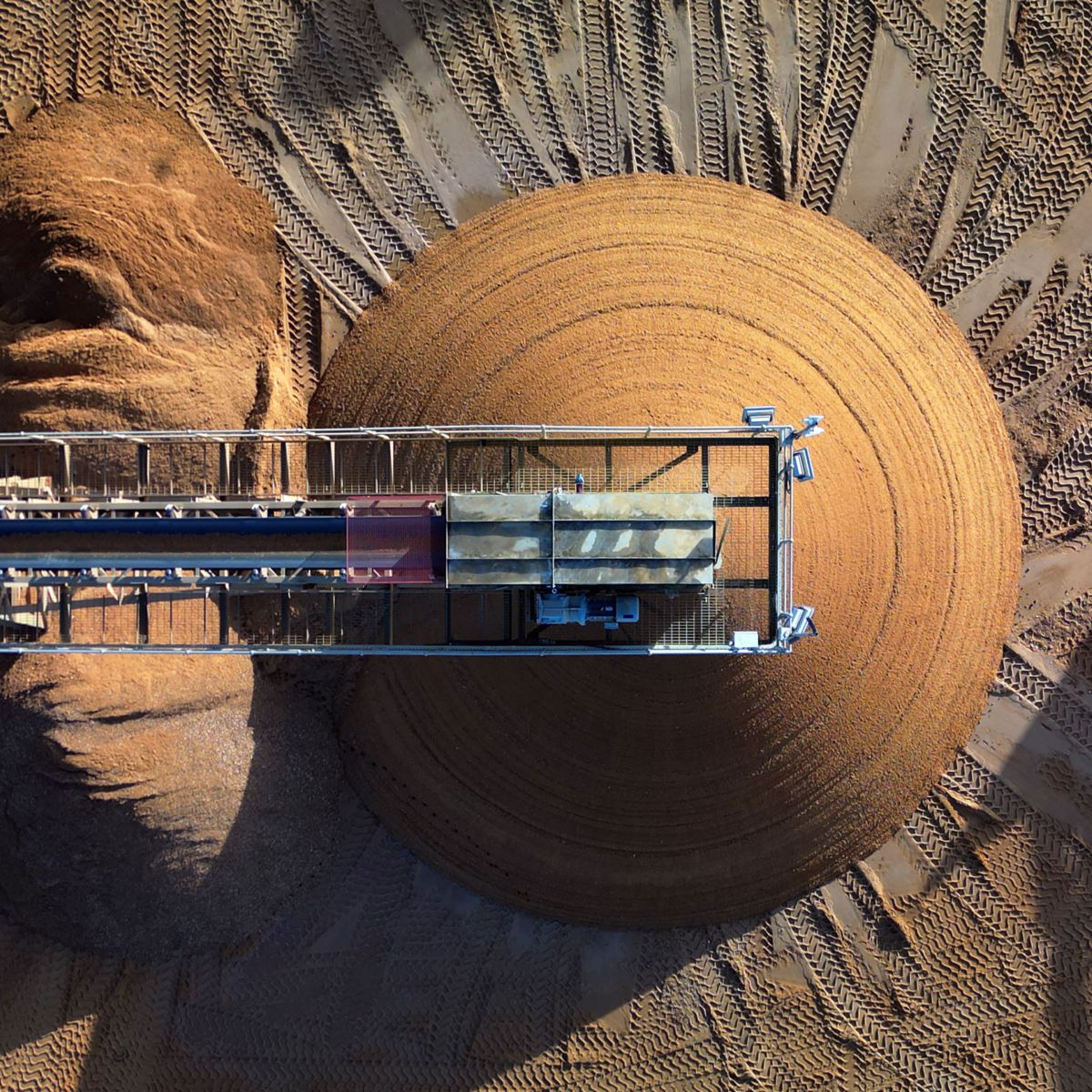Aerial mining stacker reclaimer ore stockpile
