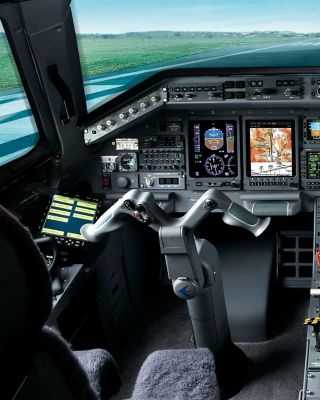 A pilot’s perspective from the cockpit, showcasing a serene green field stretching beyond the aircraft’s windshield under clear skies.