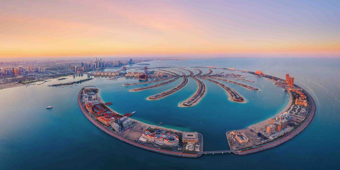 Discover Palm Jumeirah, Dubai’s iconic man-made island. Stunning aerial views showcasing luxury resorts, coastline, and world-famous architecture.