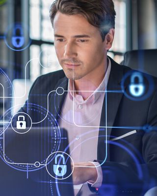 Man sitting in front of laptop for cyber security