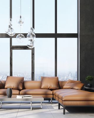 Modern living room, brown furniture, lush green accents.