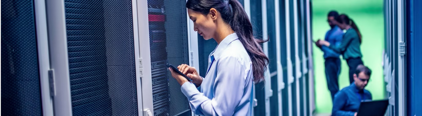 Team of engineers working in server room