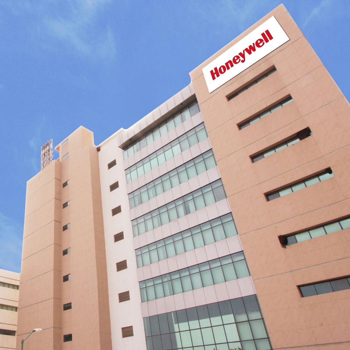 Modern Honeywell campus building in Bangalore with glass facade under a clear blue sky.