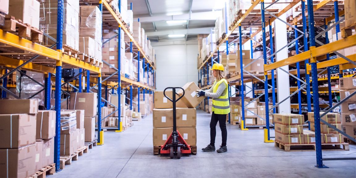 Female warehouse worker loading boxes
