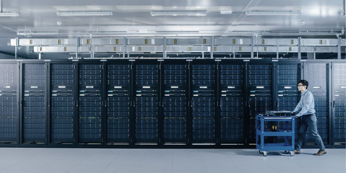 Modern Data Center: IT Technician Working with Server Racks