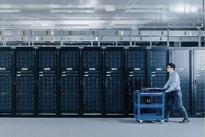 Modern Data Center: IT Technician Working with Server Racks