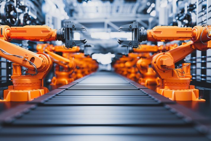 Robotic arms along assembly line in modern factory