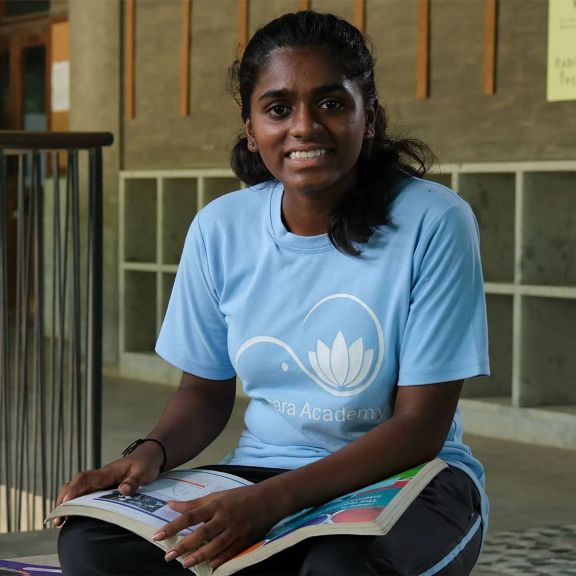 A focused student engages with her studies in a contemporary learning environment, highlighting the importance of education.