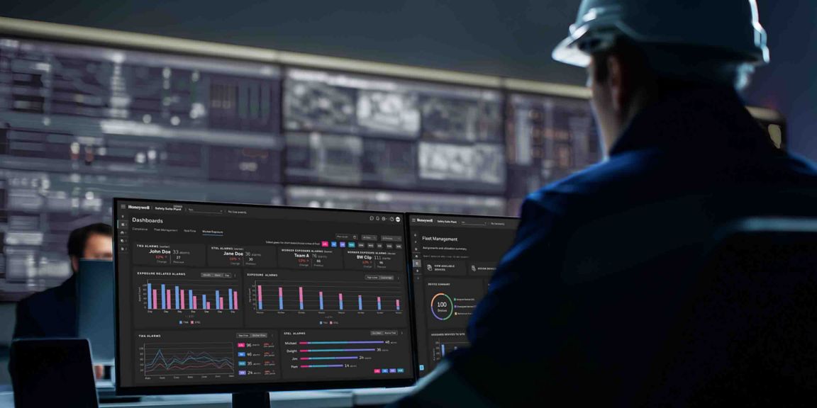 worker looking at the monitors, working on a complex ewas dashboard