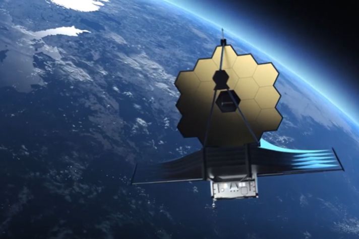 View of the James Webb Space Telescope with Earth in the backdrop.