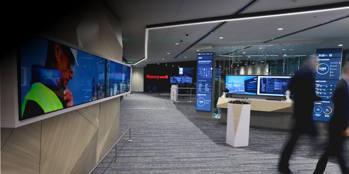 A modern Honeywell experience space featuring interactive digital displays, analytics dashboards, and cutting-edge industrial software solutions for enterprise environments.