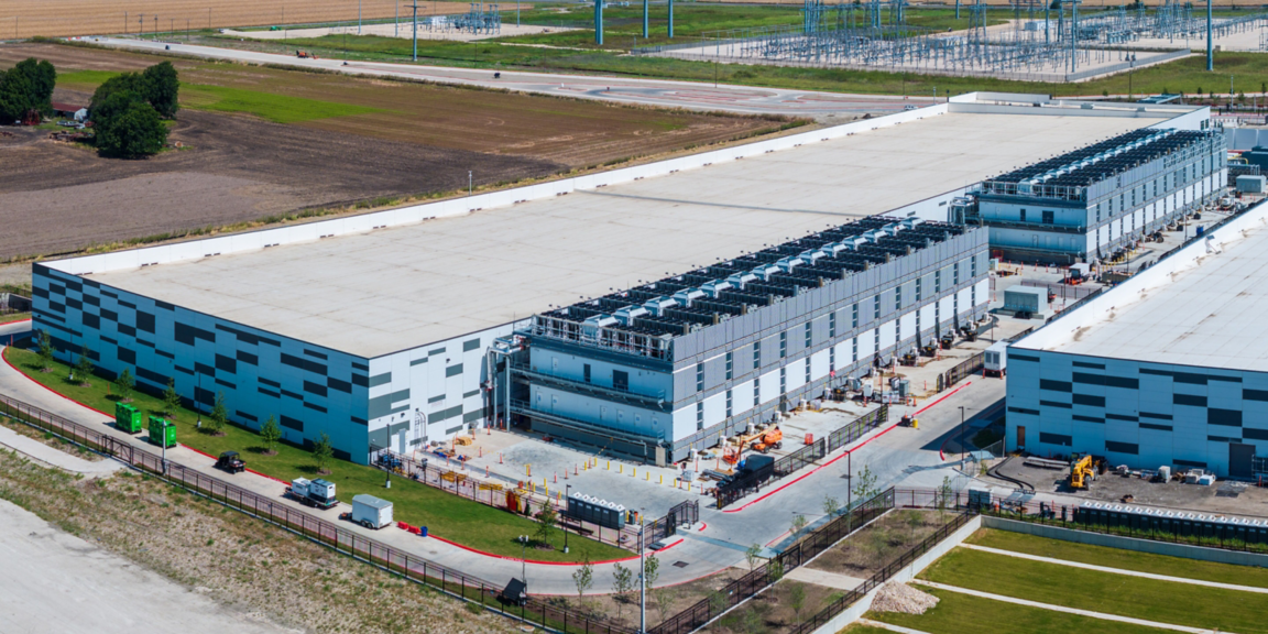 Aerial view of a large data center campus with cooling systems and electrical infrastructure supporting reliable digital operations.