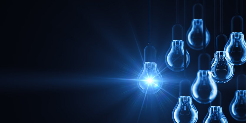 Glowing lightbulb icons form a connected digital network against a dark blue background.