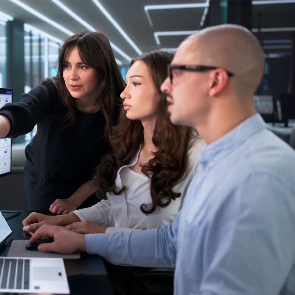 Professionals reviewing digital dashboards across multiple devices to support workplace collaboration, planning and operational decision-making.