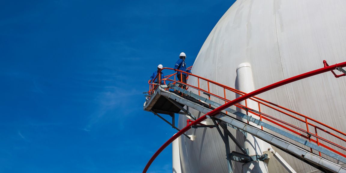 White spherical propane tanks containing fuel gas pipeline and scaffolding work