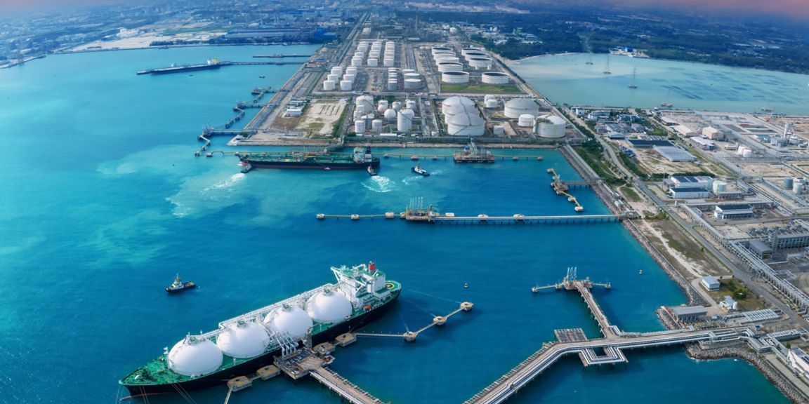 LNG (Liquified Natural Gas) tanker anchored in Gas terminal gas tanks for storage. Oil Crude Gas Tanker Ship. LPG at Tanker Bay Petroleum Chemical or Methane freighter export import transportation and logistics