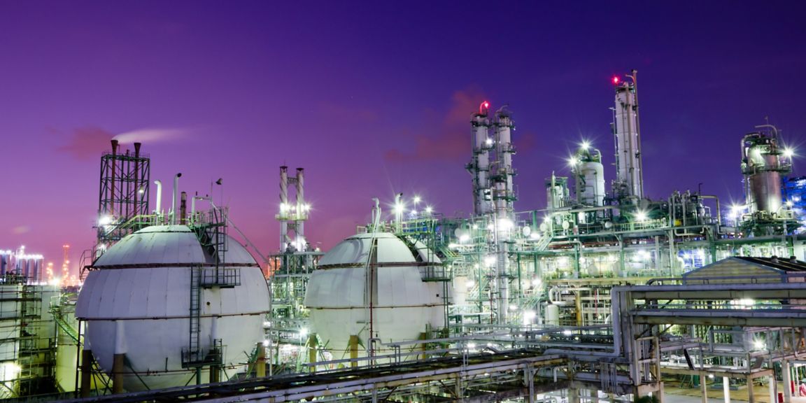 Gas storage spheres tank in petrochemical plant at night