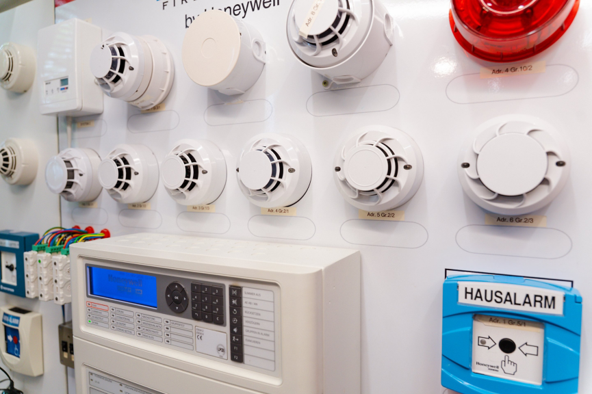Honeywell fire alarm testing board featuring various sensors, detectors, and a control console.