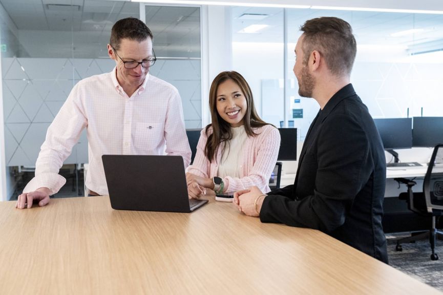 Employees working together in an open office environment, highlighting teamwork, communication, and a positive workplace culture.